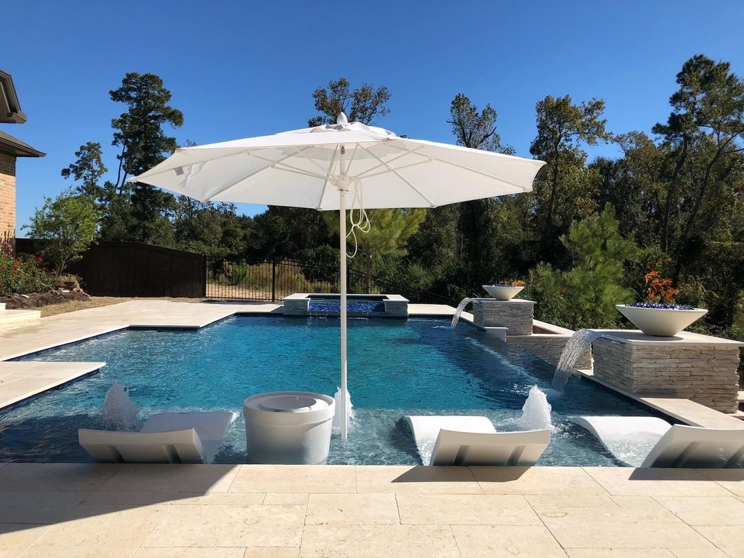 New pool with lounge chairs and water features.