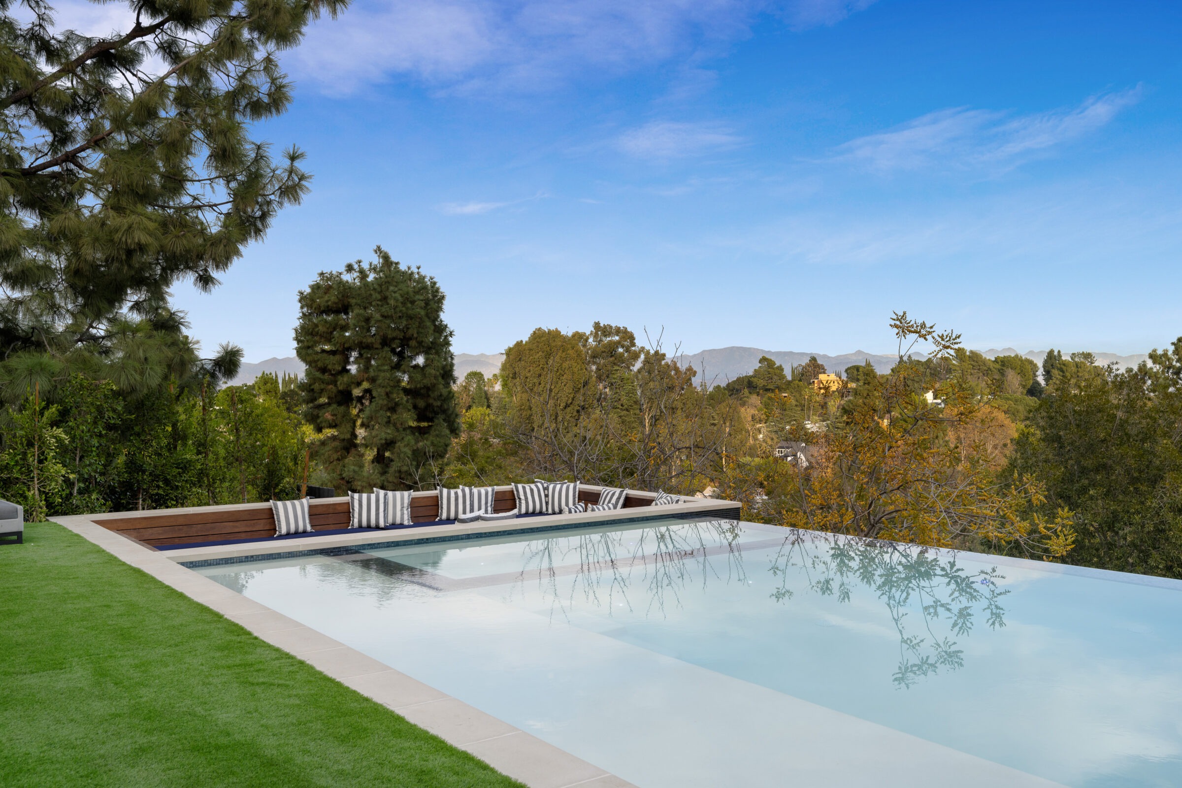 A modern infinity pool with a scenic view.